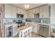 Bright kitchen features modern appliances, white cabinetry, wine cooler, and stylish backsplash at 1300 Ocean Blvd # 232, Isle of Palms, SC 29451