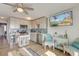 Open kitchen with modern appliances, breakfast bar, and a mounted TV at 1300 Ocean Blvd # 232, Isle of Palms, SC 29451