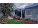 Landscaped backyard with a covered patio, flowers and lush greenery offering a private and peaceful outdoor space at 1310 Pilsdon Crest, Mount Pleasant, SC 29464