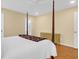This primary bedroom features a four poster bed, ceiling fan and view to the attached bathroom at 1310 Pilsdon Crest, Mount Pleasant, SC 29464