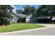 Charming one-story home featuring a well-maintained lawn, mature trees, and an attached two car garage at 1310 Pilsdon Crest, Mount Pleasant, SC 29464