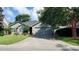 Charming one-story home featuring a well-maintained lawn, mature trees, and an attached two car garage at 1310 Pilsdon Crest, Mount Pleasant, SC 29464