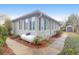 Stylish home exterior featuring a propane tank, a walkway, and lush landscaping at 1310 Pilsdon Crest, Mount Pleasant, SC 29464
