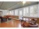 Bright sunroom featuring wood floors, seating, ceiling fans, and access to the outdoor space at 1310 Pilsdon Crest, Mount Pleasant, SC 29464