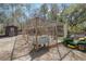 A backyard with a chicken coop, shed, and John Deere lawn mower showcasing outdoor features at 1365 Whippoorwill Farm Rd, Johns Island, SC 29455