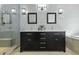 Bathroom featuring dual vanities, tile flooring, a glass-enclosed shower, and modern lighting fixtures at 1365 Whippoorwill Farm Rd, Johns Island, SC 29455