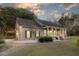 Charming home with a covered porch, landscaped yard, and brick pathway leading to the entrance at 1365 Whippoorwill Farm Rd, Johns Island, SC 29455