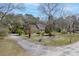 Charming home with a long driveway surrounded by mature trees, showcasing curb appeal at 1365 Whippoorwill Farm Rd, Johns Island, SC 29455