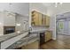 Kitchen with a granite island, stainless sink, wood cabinets, and view into the living room with fireplace at 1365 Whippoorwill Farm Rd, Johns Island, SC 29455