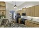 Kitchen featuring stainless appliances, wood cabinetry, granite countertops, and wood flooring at 1365 Whippoorwill Farm Rd, Johns Island, SC 29455