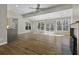 Spacious living room featuring a fireplace, hardwood floors, and large windows offering natural light at 1365 Whippoorwill Farm Rd, Johns Island, SC 29455