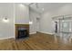 Cozy living room with fireplace, hardwood flooring, and an open doorway leading to other rooms at 1365 Whippoorwill Farm Rd, Johns Island, SC 29455