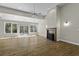 Bright living room featuring vaulted ceiling, hardwood floors, fireplace, and sliding glass doors to the back at 1365 Whippoorwill Farm Rd, Johns Island, SC 29455