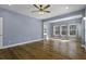 Living room with hardwood floors, light blue walls, and natural light coming through multiple windows at 1365 Whippoorwill Farm Rd, Johns Island, SC 29455
