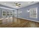 Living room with hardwood floors, light blue walls, and lots of natural light from the many windows at 1365 Whippoorwill Farm Rd, Johns Island, SC 29455