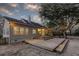 Backyard with a large wooden deck, outdoor lighting, and mature trees providing shade and privacy at 1365 Whippoorwill Farm Rd, Johns Island, SC 29455