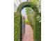 Landscaped backyard with a brick pathway through lush greenery, creating a serene outdoor escape at 15 Menotti St, Charleston, SC 29401