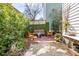 Cozy backyard retreat featuring brick-paved area, comfortable seating, and lush greenery for relaxation at 15 Menotti St, Charleston, SC 29401