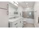 Modern bathroom with marble countertop, white cabinets, subway tile and a bathtub with shower at 15 Menotti St, Charleston, SC 29401