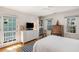 Bright, airy bedroom features hardwood floors, two windows and glass paned door to balcony at 15 Menotti St, Charleston, SC 29401