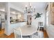Dining area adjacent to kitchen featuring stylish lighting and comfortable seating arrangements at 15 Menotti St, Charleston, SC 29401