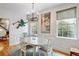 Refined dining area with artistic decor, hardwood floors, and natural light from large windows at 15 Menotti St, Charleston, SC 29401