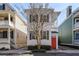 Charming home with white siding, wood shutters, and an inviting orange front door at 15 Menotti St, Charleston, SC 29401