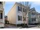 Side view of a charming home with white siding, wood shutters, and an inviting orange front door at 15 Menotti St, Charleston, SC 29401