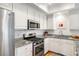 Well-lit kitchen featuring stainless steel appliances, sleek countertops, and ample cabinet space at 15 Menotti St, Charleston, SC 29401