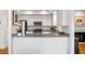 Bright, open kitchen area with granite countertops, stainless steel appliances, and white cabinets at 15 Menotti St, Charleston, SC 29401