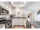 Modern kitchen equipped with stainless steel appliances, granite countertops, and white cabinetry at 15 Menotti St, Charleston, SC 29401