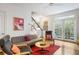 Comfortable living room featuring hardwood floors, a staircase, and French doors leading outside at 15 Menotti St, Charleston, SC 29401