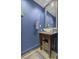 Stylish bathroom with a vessel sink, granite countertop, and blue accent walls at 150 Bee St # 312, Charleston, SC 29401