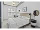 Sunlit bedroom featuring a ceiling fan, neutral walls, and a comfortable bed at 150 Bee St # 312, Charleston, SC 29401