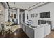 Open-concept living space with a comfortable sofa, industrial-style elements, and a modern dining area at 150 Bee St # 312, Charleston, SC 29401