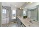 Spa-like bathroom with double vanities, a glass-enclosed shower, and serene natural light at 1583 Trailmore Ln, Summerville, SC 29486