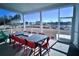 Covered porch with comfortable dining set and beautiful neighborhood views, perfect for outdoor relaxation at 1583 Trailmore Ln, Summerville, SC 29486