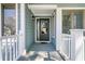 Charming covered front porch with gray door and white railings at 1715 Greystone Blvd Blvd # 25, Mount Pleasant, SC 29464
