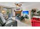 A cozy living room with a wood-burning fireplace and comfortable seating on a plush black couch at 1715 Greystone Blvd Blvd # 25, Mount Pleasant, SC 29464
