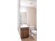 Neat bathroom featuring a dark vanity and white toilet; offers simple elegance at 1749 Towne St, Johns Island, SC 29455