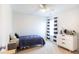 This bedroom has a ceiling fan, a dresser, and stylish striped curtains at 1749 Towne St, Johns Island, SC 29455
