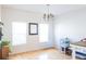 Bright, empty dining room space with hardwood floors, a modern chandelier, and multiple windows at 1749 Towne St, Johns Island, SC 29455