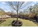 Landscaped backyard featuring plush grass, a mulched planting bed, and a lovely seating area at 1962 Bellona St, Charleston, SC 29492