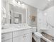 Well-lit bathroom features double vanity, large mirror, ceramic tile floors, and glass shower stall at 1962 Bellona St, Charleston, SC 29492