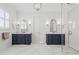 Luxurious bathroom with double vanities, framed mirrors, and glass shower doors at 1962 Bellona St, Charleston, SC 29492