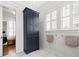 Bathroom showcasing tall navy storage cabinet, shiplap walls, and window shutters at 1962 Bellona St, Charleston, SC 29492