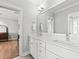 Bathroom features double vanity, large mirror, and white cabinets and drawers at 1962 Bellona St, Charleston, SC 29492