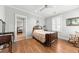 Charming bedroom with hardwood floors, ceiling fan, and view into adjoining room at 1962 Bellona St, Charleston, SC 29492