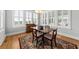 Dining room featuring a wooden table, antique rug, and large shuttered windows for natural light at 1962 Bellona St, Charleston, SC 29492