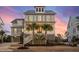 Charming two-story home featuring classic architecture and beautiful landscaping with palm trees at 1962 Bellona St, Charleston, SC 29492
